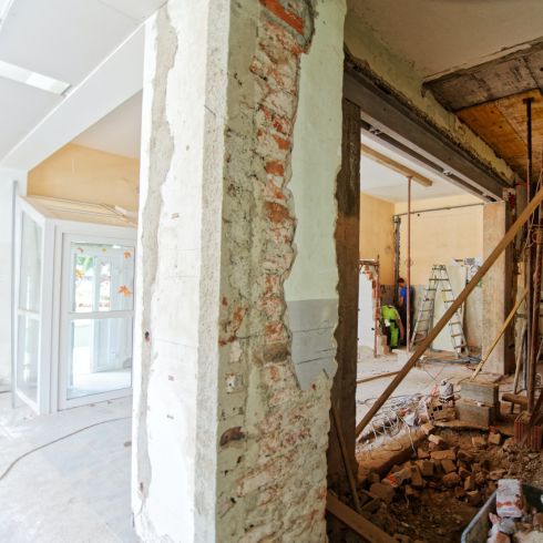 Old home being renovated and gutted with brick wall