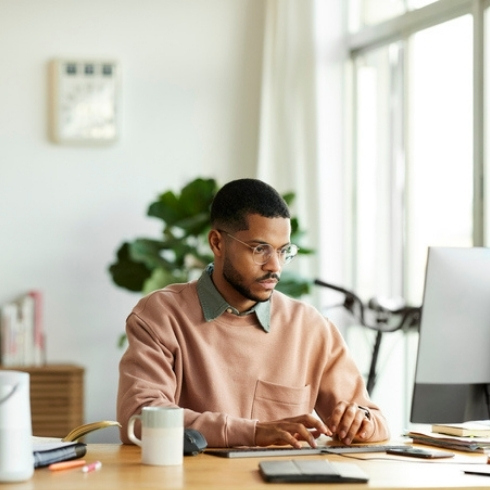 Freelancer Using Computer At Home Office