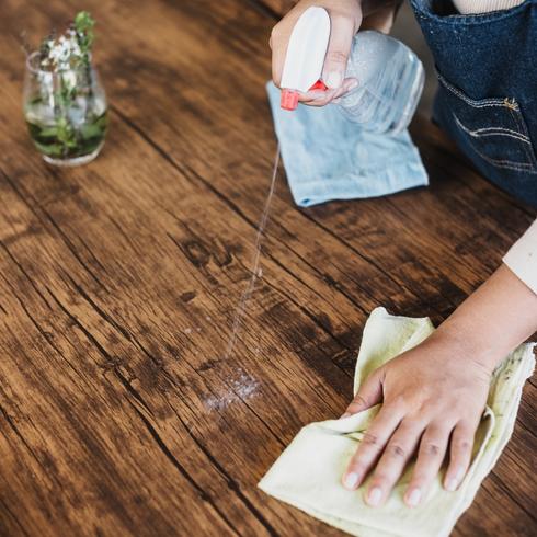 Person wiping countertop