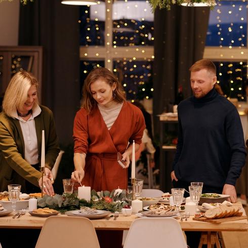 Friends setting table for a dinner party