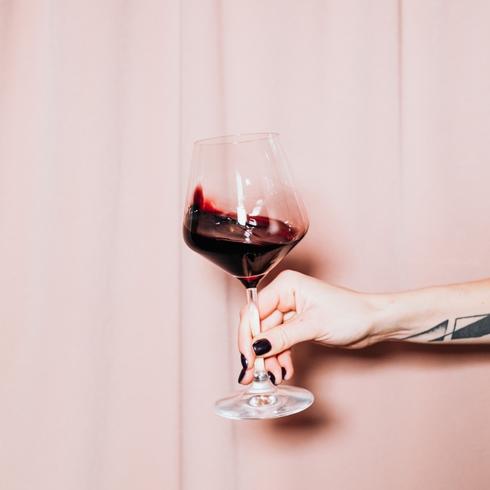 Person holding a glass of wine