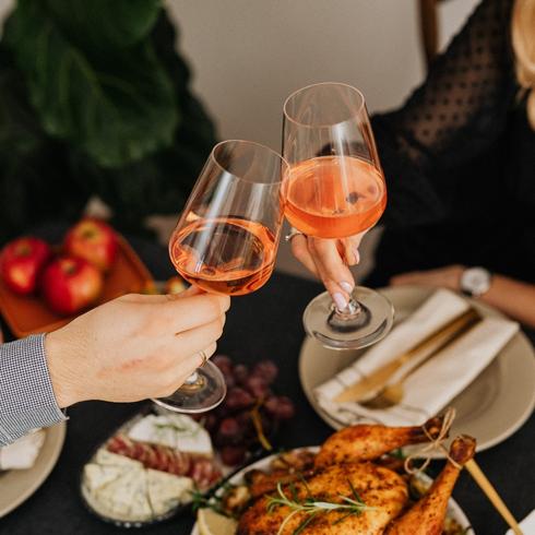 Toasting with wine at a dinner table