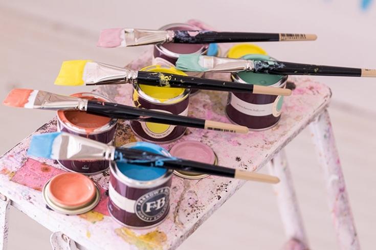 Samples of different colours of paint and different angled paint brushes 