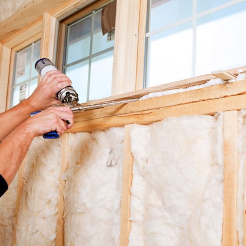 Home insulation beneath a basement window