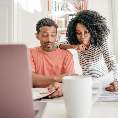 couple look at papers in white kitchen