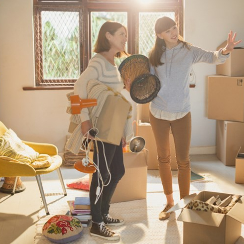 mother and daughter packing boxes