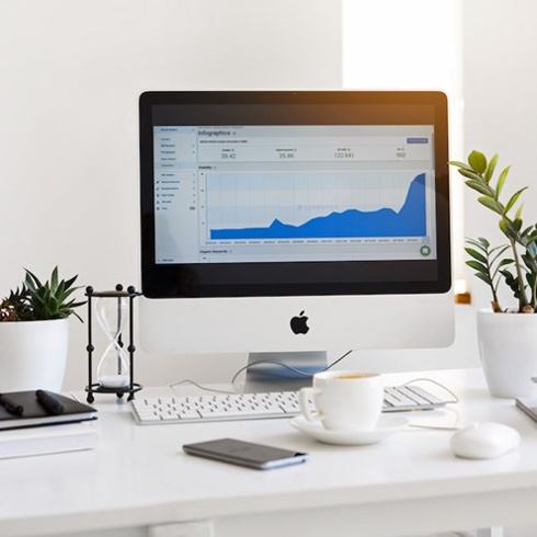 Desktop computer on desk in white room