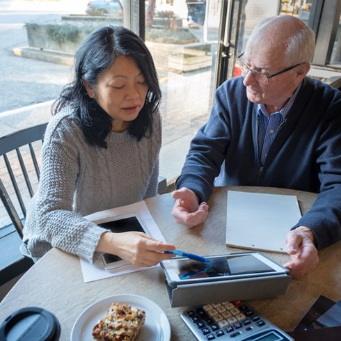 Couple looking at table on wood table