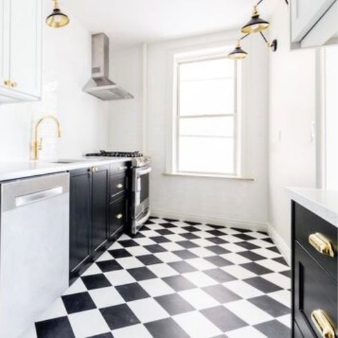 black and white kitchen with checkered floor