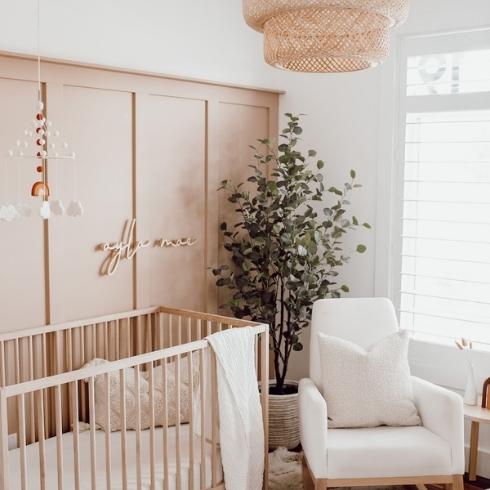 Neutral nursery with wood-panelled closet