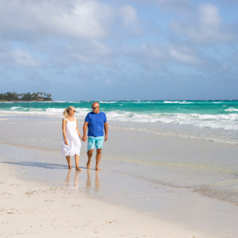 Bryan and Sarah walking on an empty beach.