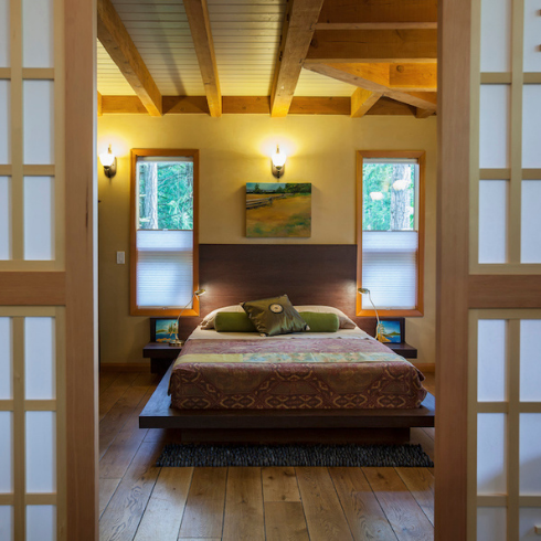 patterned bed in yellow bedroom with shoji screens