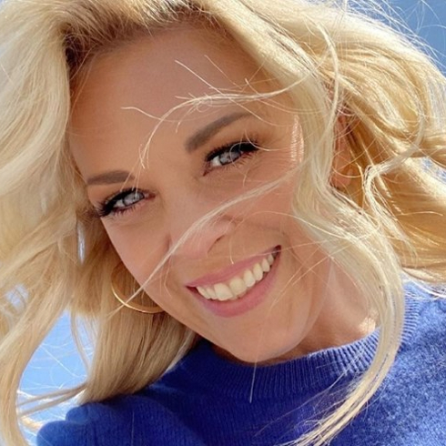 Kortney Wilson selfie smiling in a blue sweater