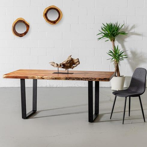 wood-topped dining table in white room