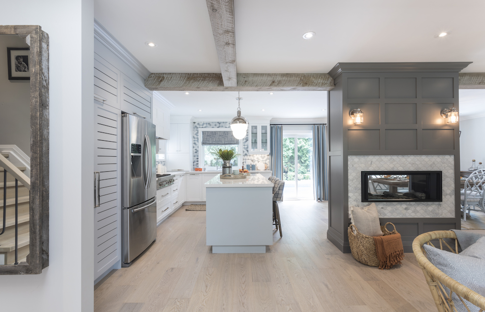 Newly renovate kitchen with maple floors, ice blue centre island and gas fireplace