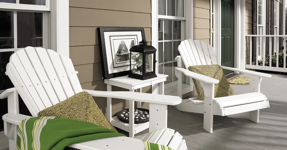 Beautiful beach inspired back porch painted light brown in BEHR Mocha Latte PPU5-04 with white trim in BEHR Ultra Pure White® PPU18-06 and a green door in BEHR Vine Leaf N400-7