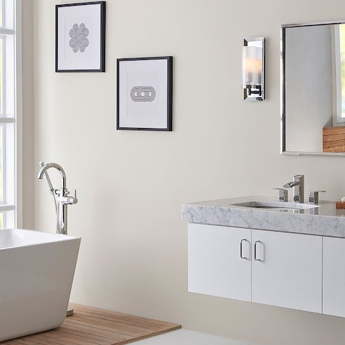 Modern white bathroom with rectangular standalone bathtub in front of large windows, a double sink floating vanity, two wall mirrors, two wall sconces, and walls painted with BEHR Dove HDC-MD-21