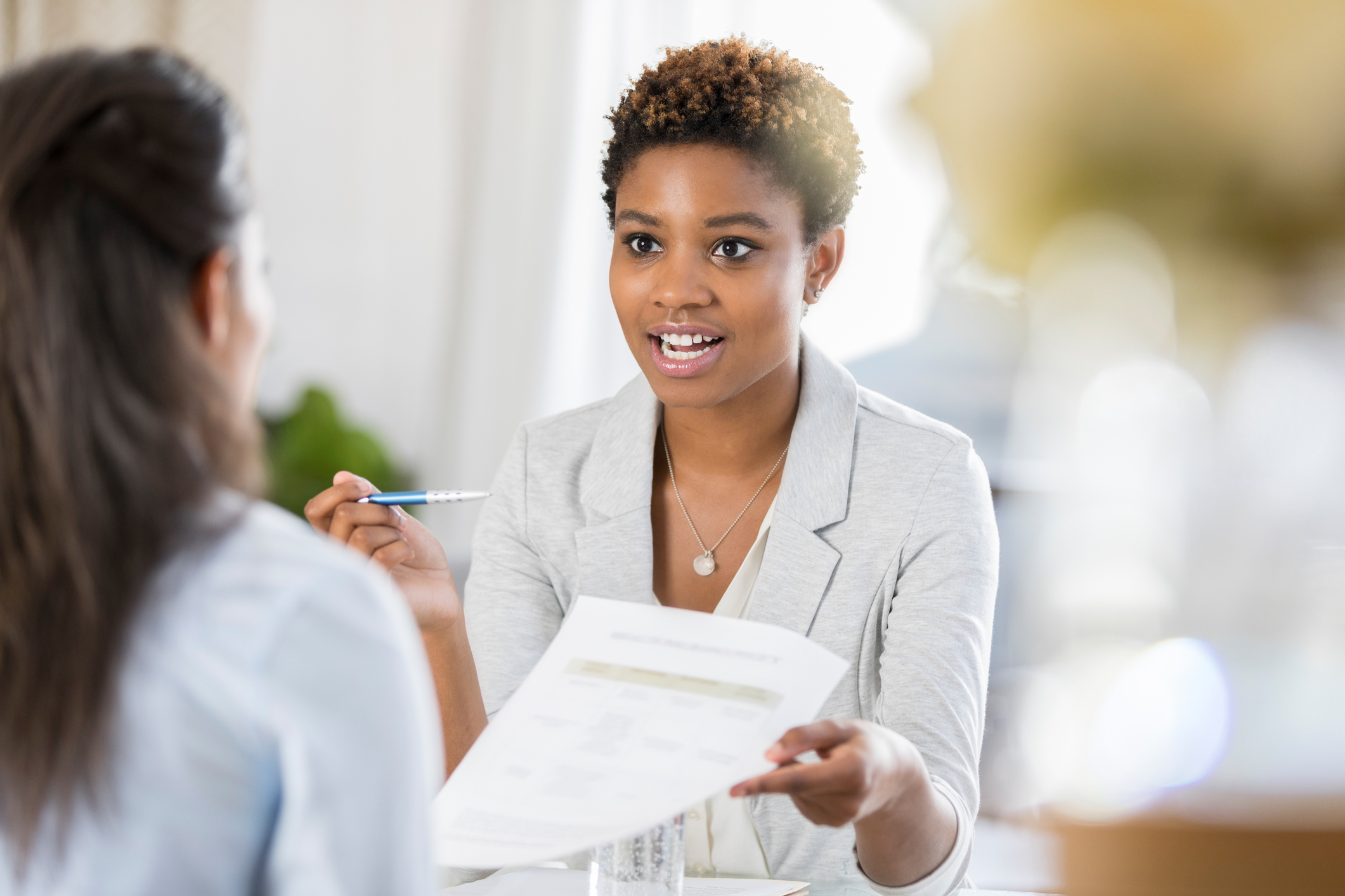 Women discussing a document