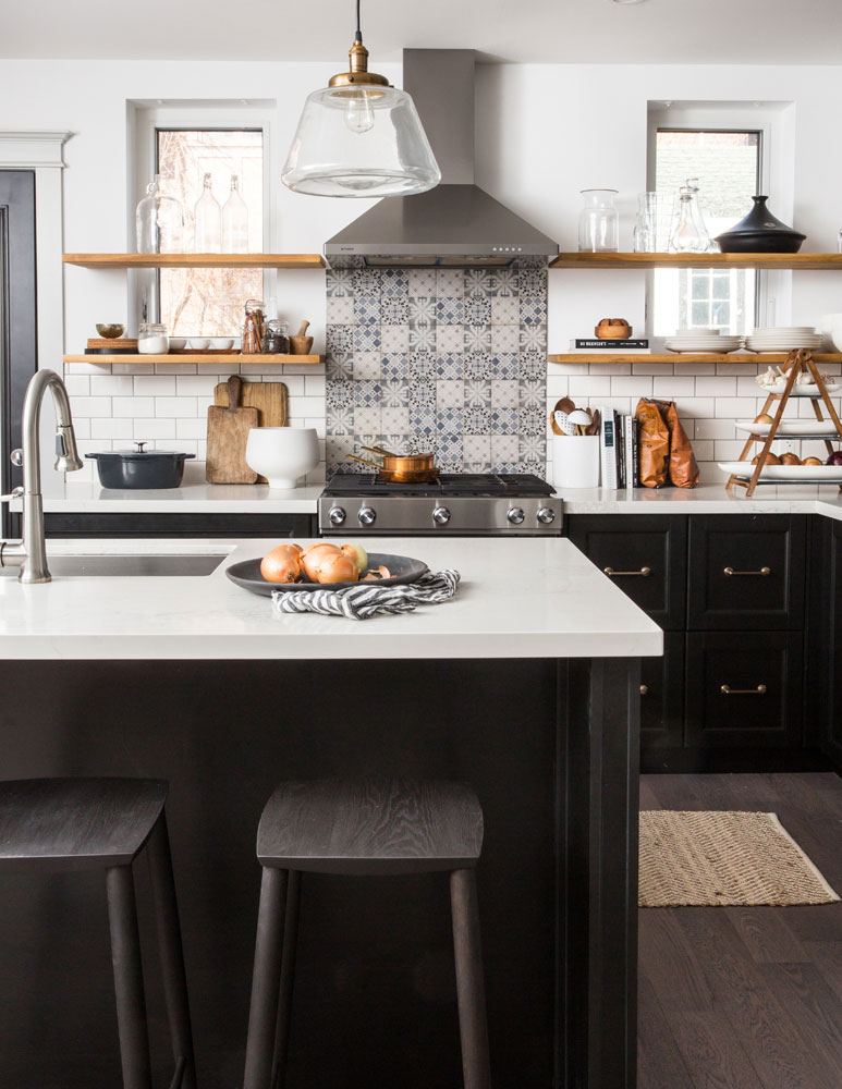 Subway tiles combined with mosaic backsplash topped with floating shelves.