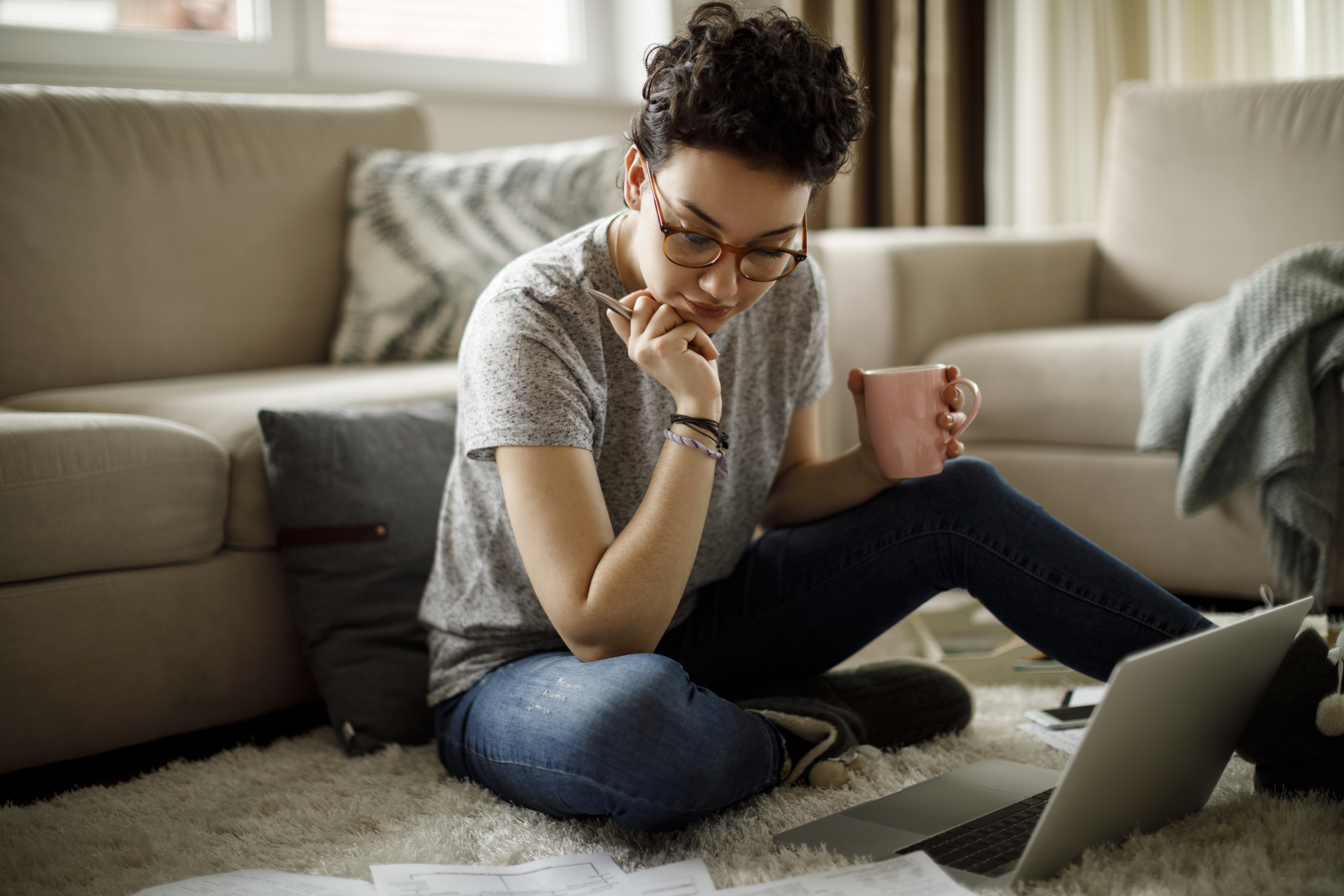 Young woman reviewing document on computer