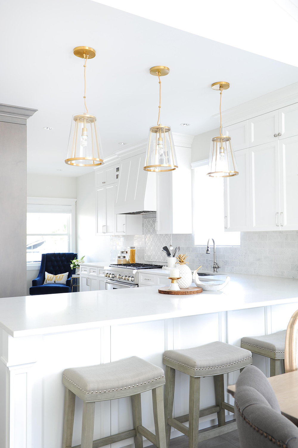 When Lighting Strikes Modern white kitchen with glam gold accents