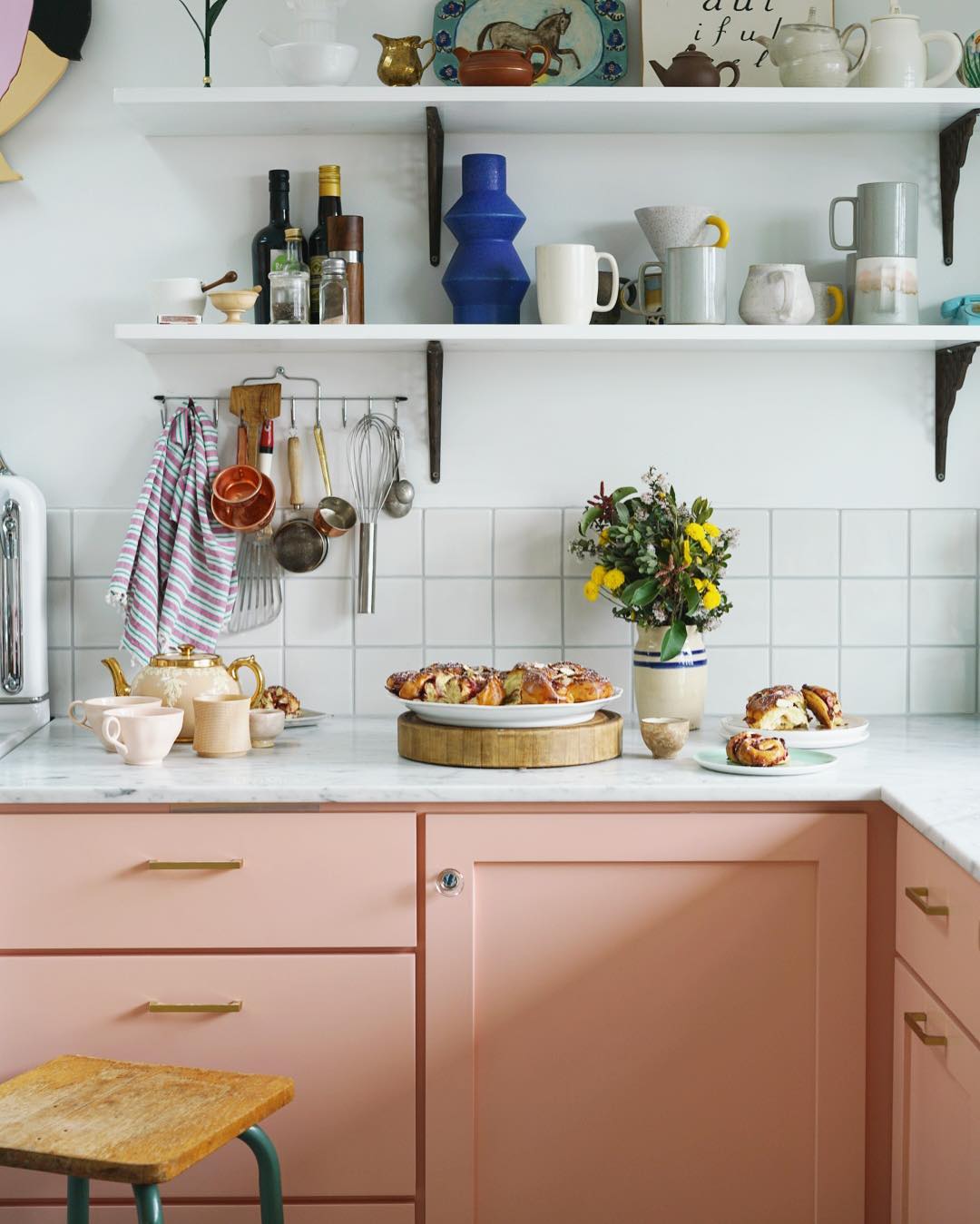 Charming kitchen with soft pink cabinets.