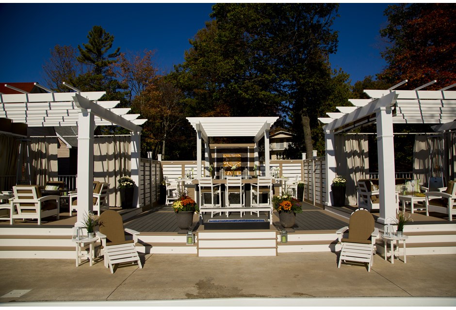 Three white pergolas on one large backyard deck