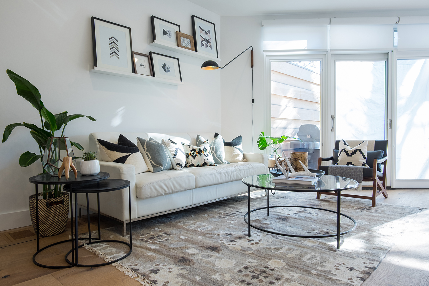 living room with three glass patio doors on angled wall