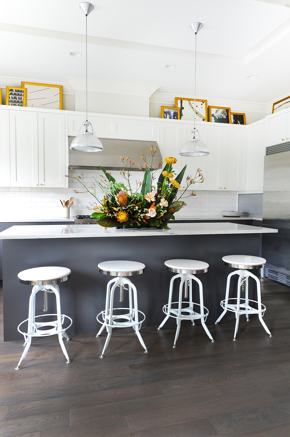 Art Attack Modern white kitchen with glam artwork.