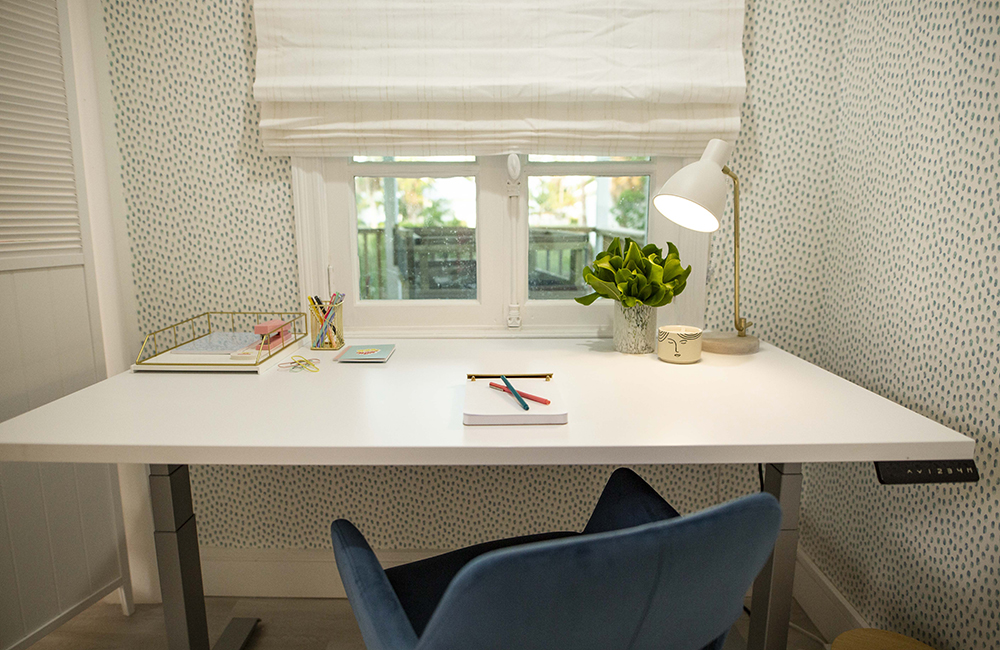 A desk with notebook and lamp