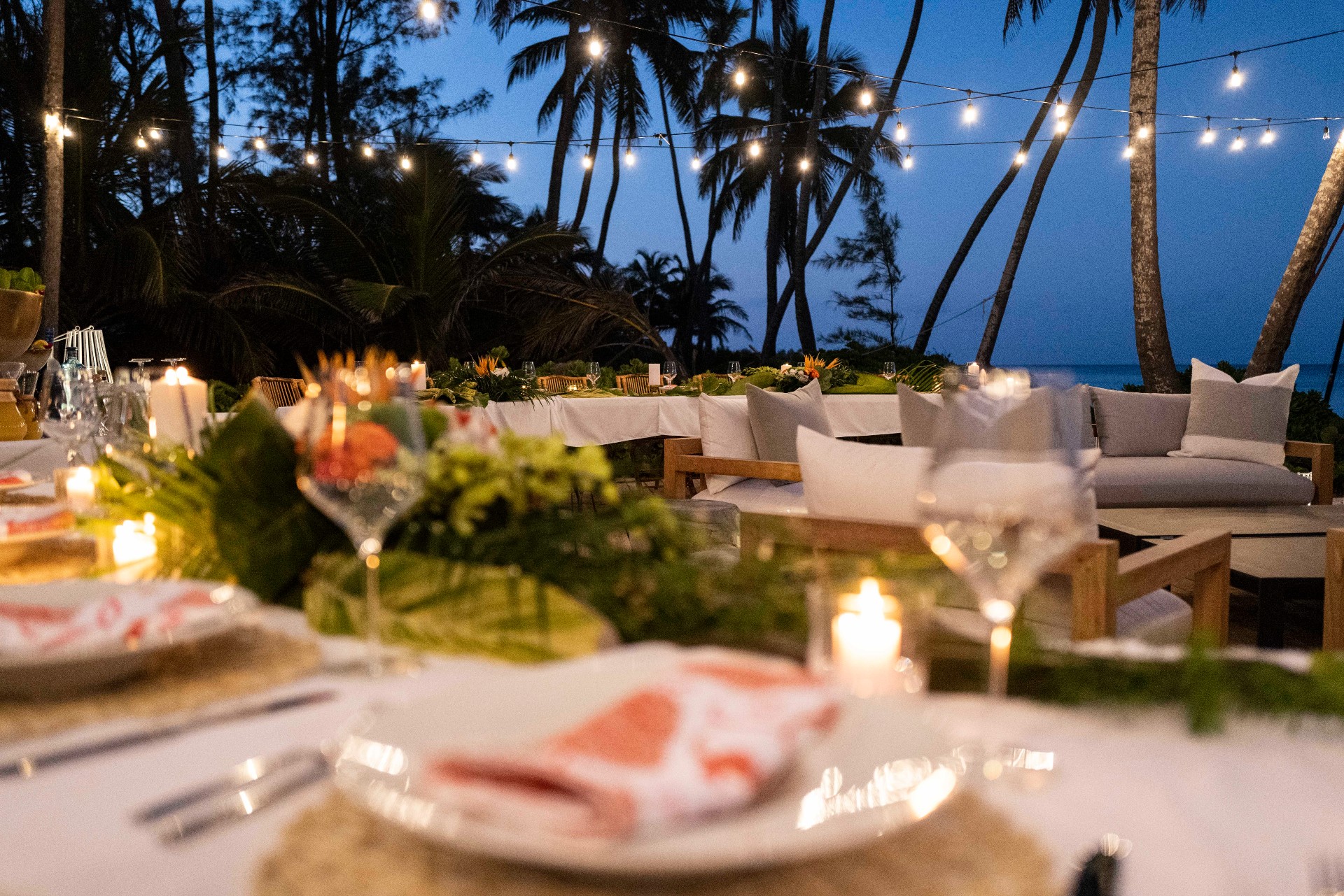 Outdoor dining area with set tables and string lights