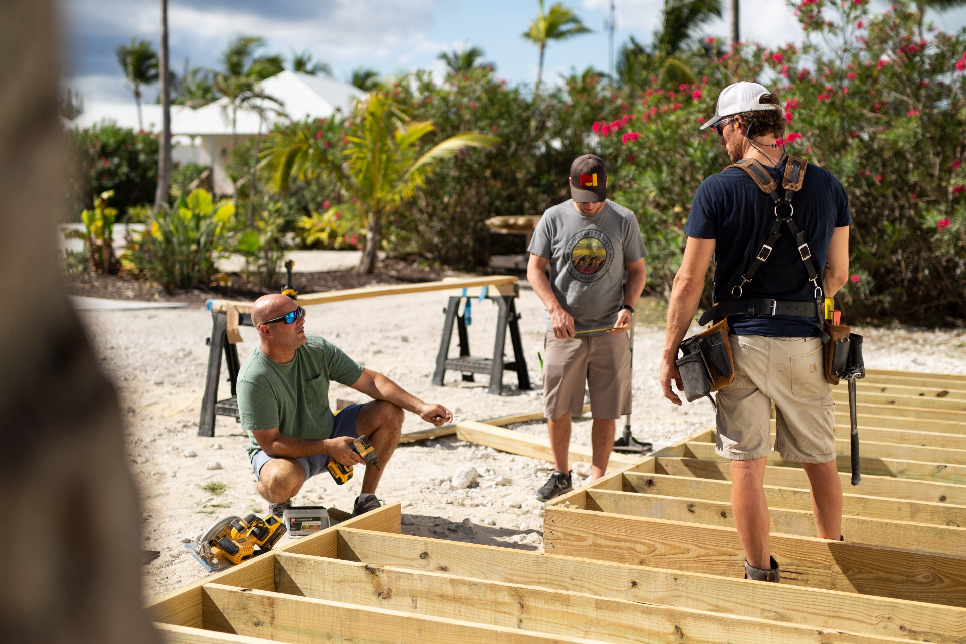 Bryan building deck on beach with 2 helpers