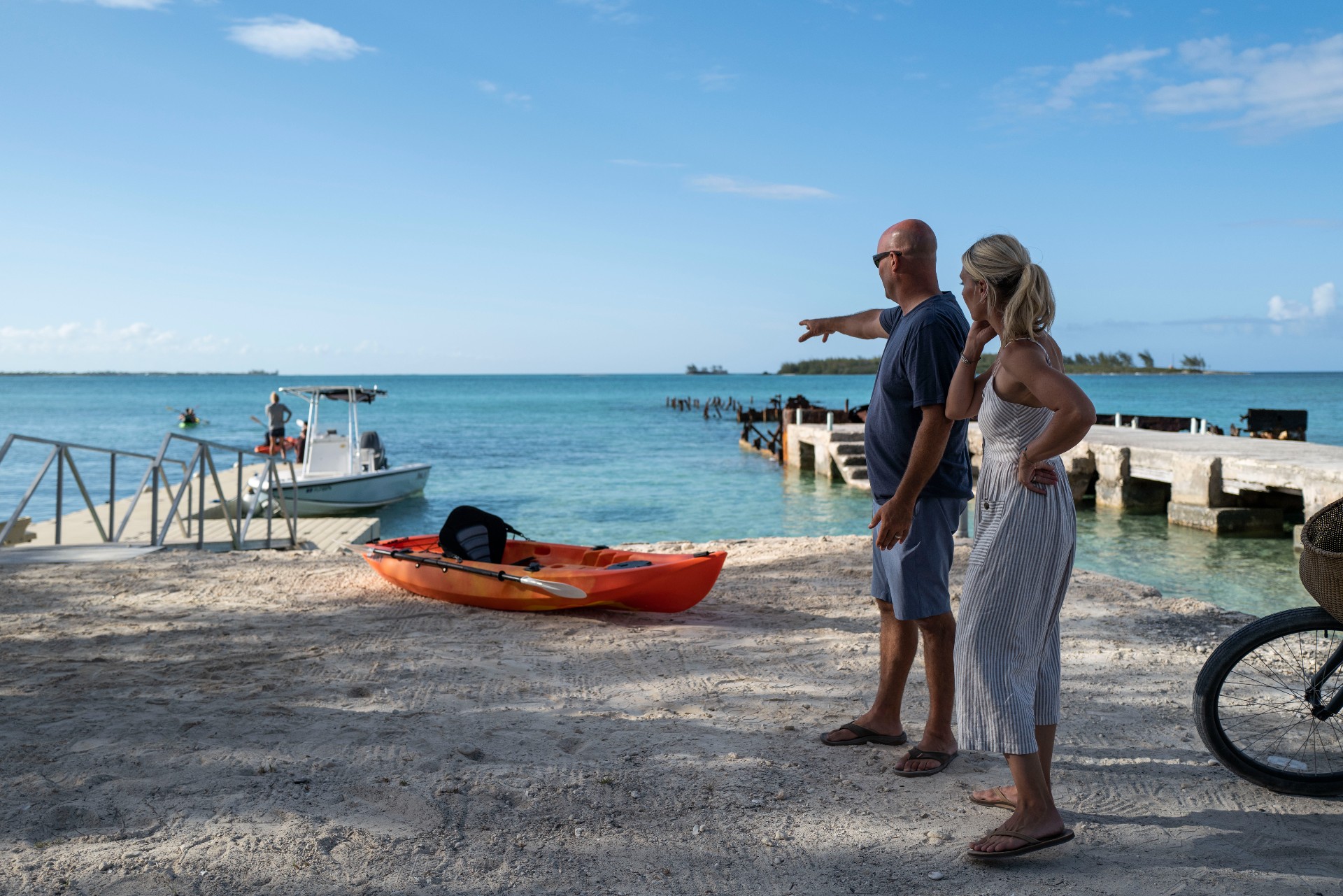 Sarah and Bryan Baeumler looking out at dock from shore