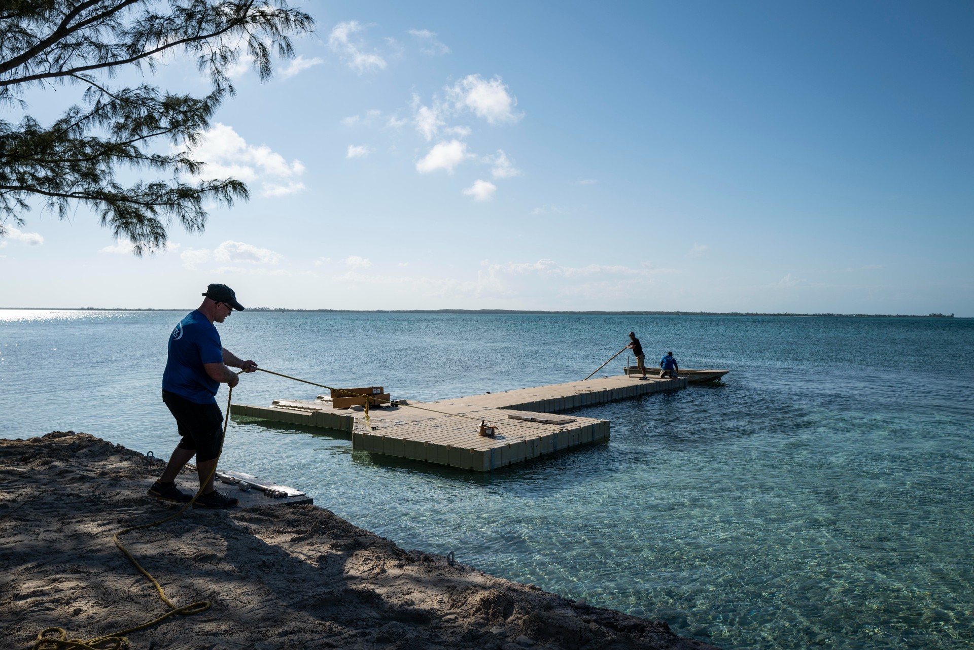 Man pulling floating dock on the ocean