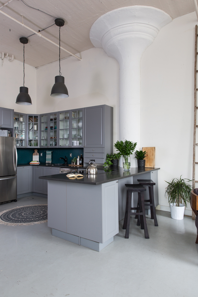 Cool loft space with functional kitchen and glass cabinets.