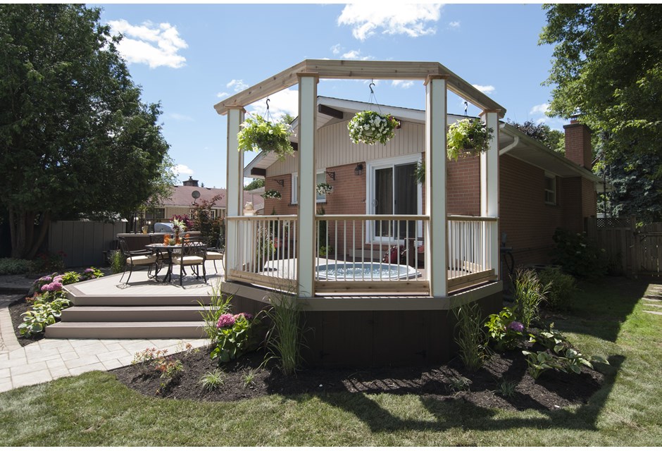 A chic pergola in the style of a gazebo near a small outdoor hot tub