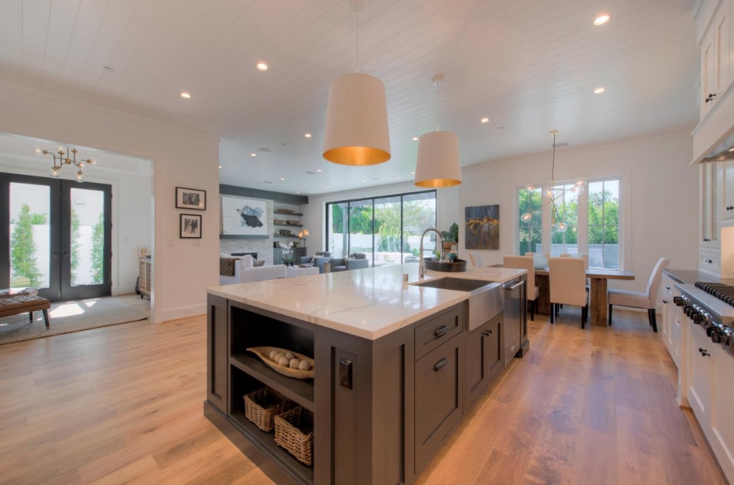 Spacious kitchen with marble-topped island and hardwood flooring