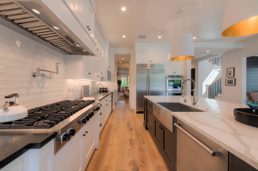 The gourmet kitchen features three sinks and two dishwashers