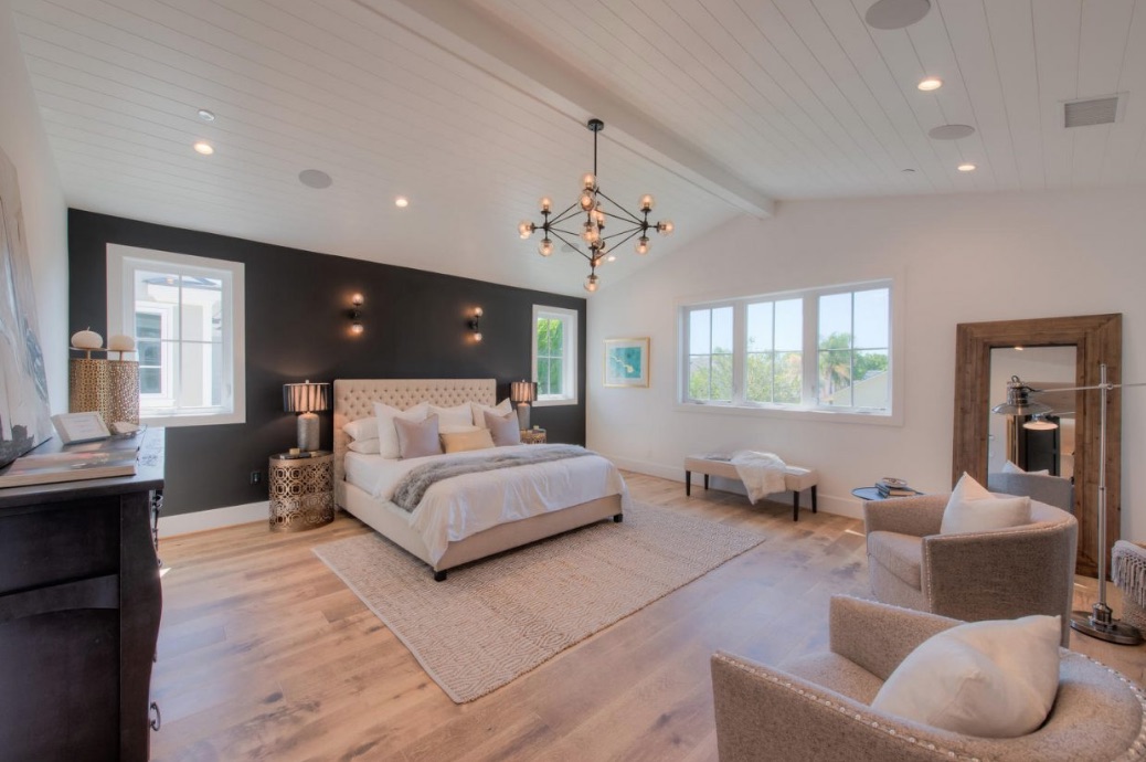 A large master bedroom with plenty of light and neutral colour tones