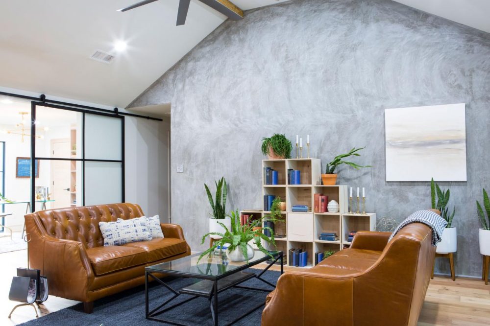 living room with sponged grey focal wall and two tan leather sofas