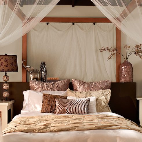 Pretty Asian-inspired bedroom with a large canopy bed, silk bedding in various shades of bronze and cream, and walls painted with BEHR Off White 73, Havana Coffee N210-7 and Shiitake N220-4