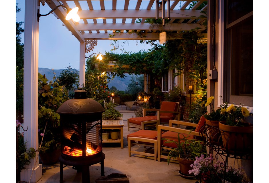 A small fire pit under a pergola