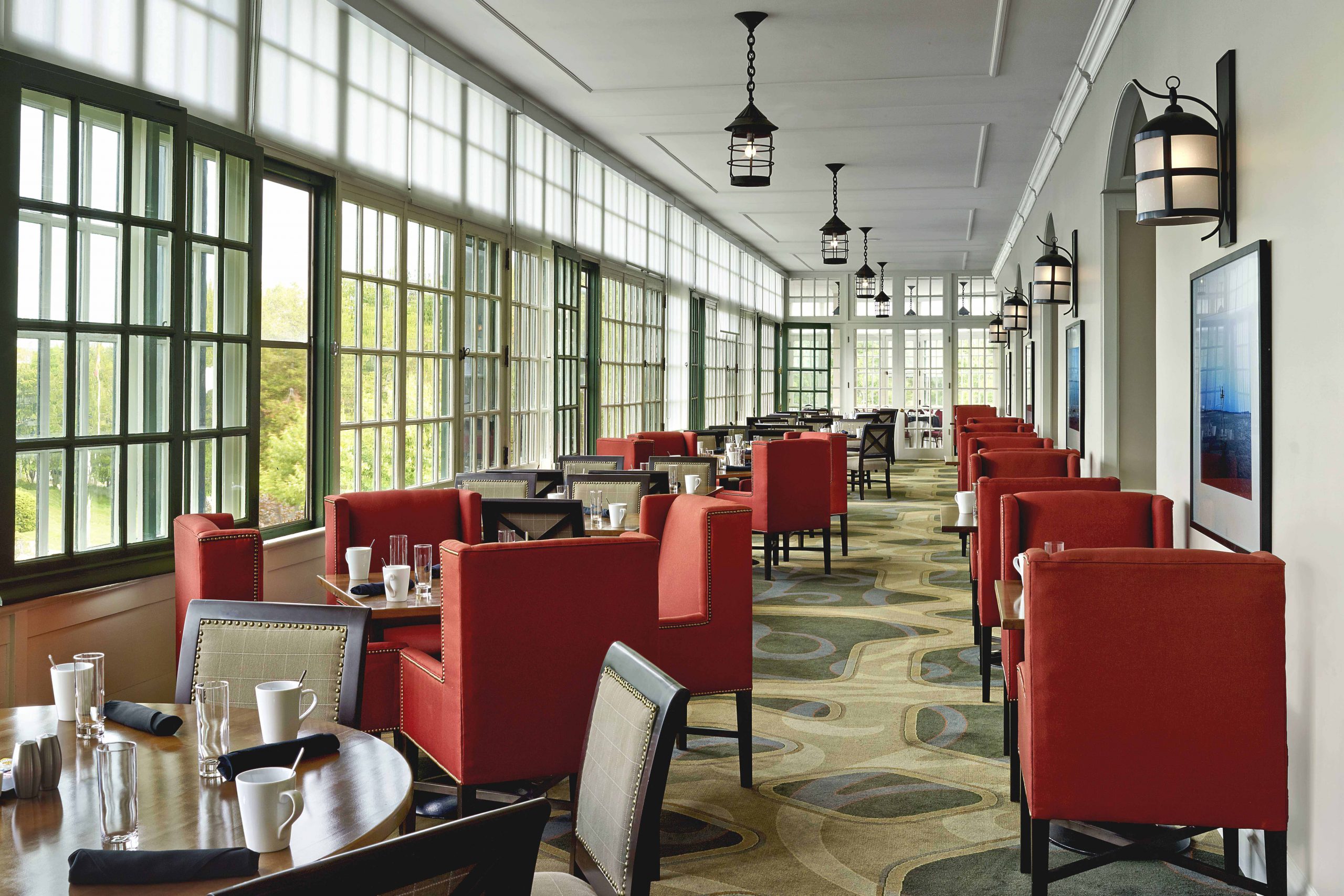 Elegant dining hall with bright red chairs