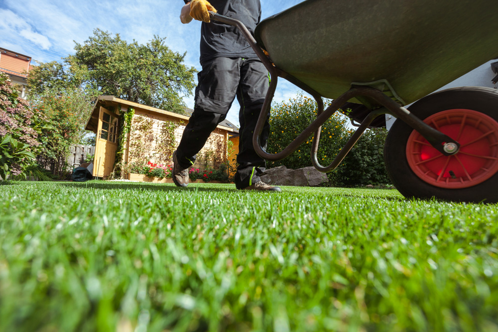 Worker pushing wheelbarrow