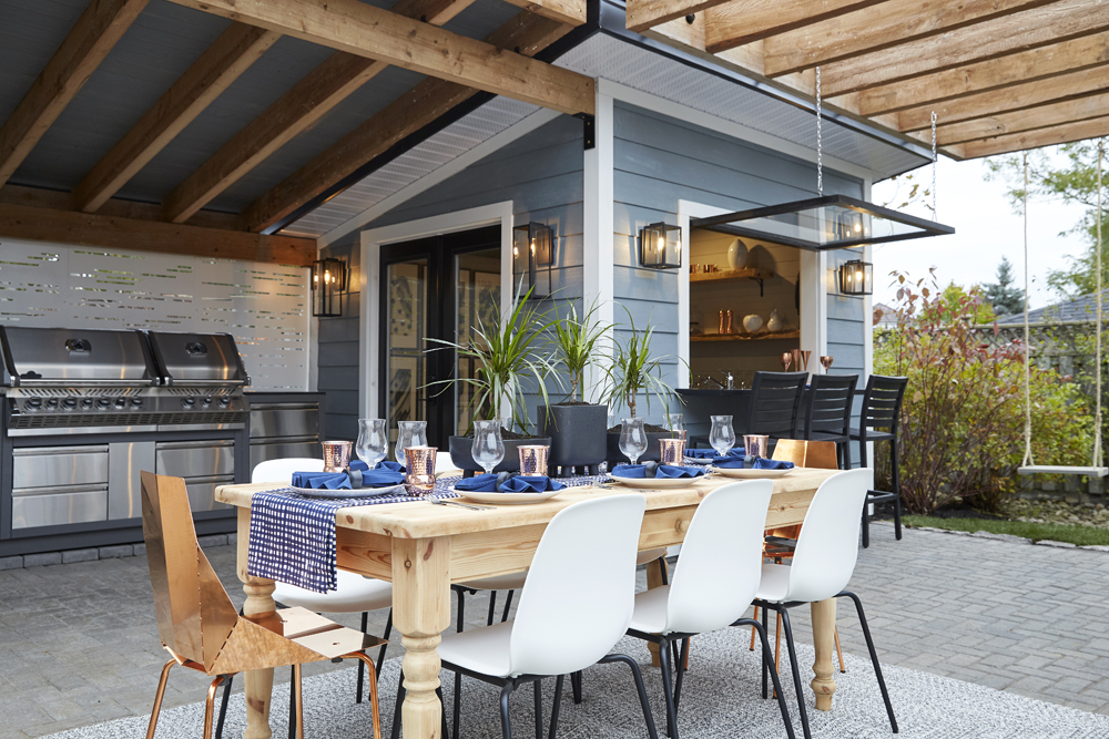 A spacious outdoor kitchen complete with tiled flooring, swing set and BBQ area