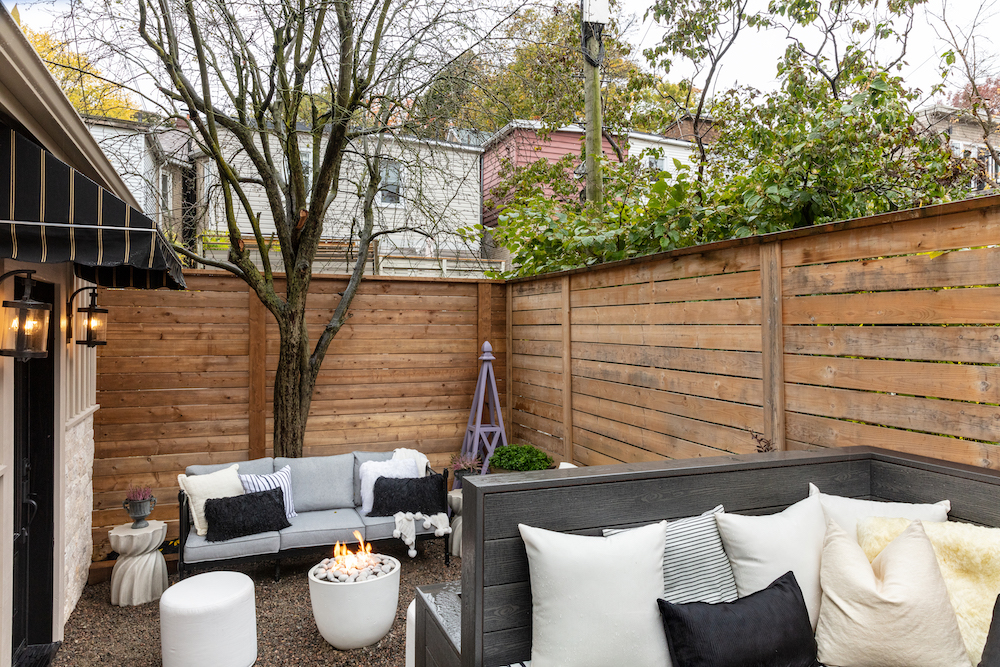 backyard lounge with seating, firepit and purple DIY garden structure