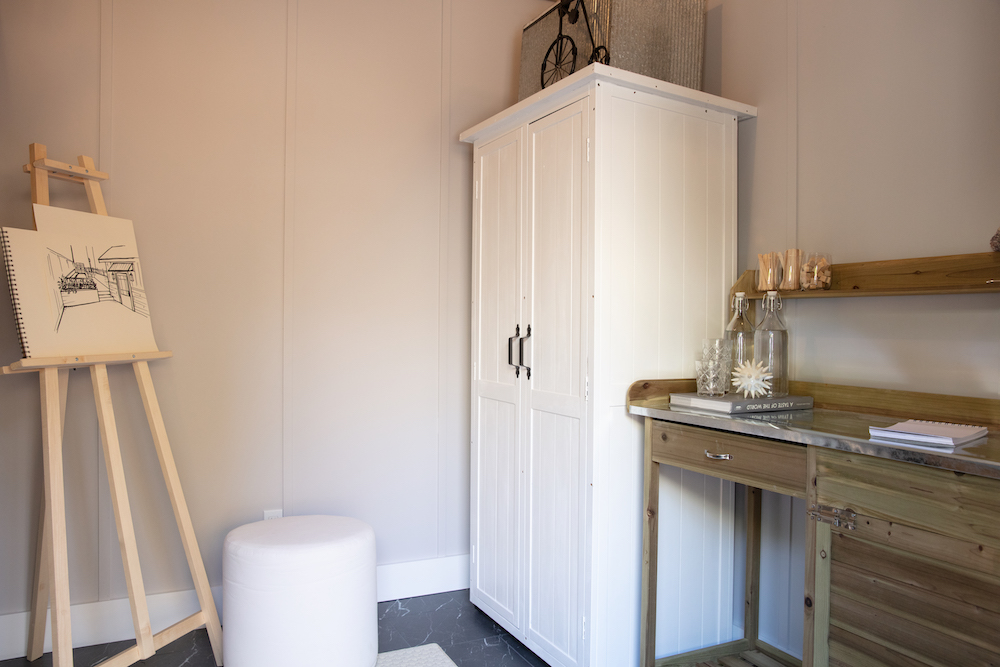 grey interior of bistro structure with white cabinet and art supplies