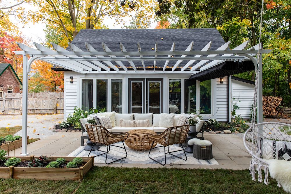 outdoor patio with pergola in front of white converted garage