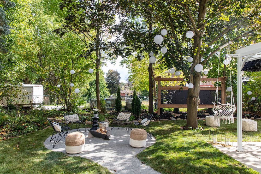 outdoor lounge with seating around firepit and privacy screen