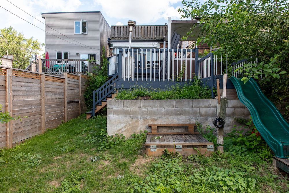 before of backyard with wooden deck and slide